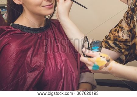 Makeup Artist Applies Red Lipstick . Beautiful Woman Face. Hand Of Make-up Master, Painting Lips Of 