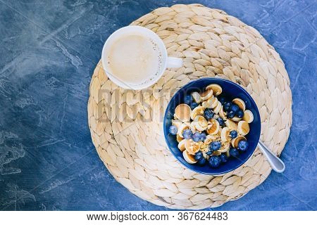 Morning, Breakfast Time, Cereal Mini Pancake, Mini Pancakes In A Dark Blue Bowl With Maple Sirup Hon
