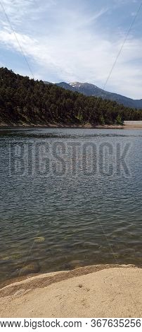 Engolasters Lake, Moving Water Point Of View Surrounded By Mountains
