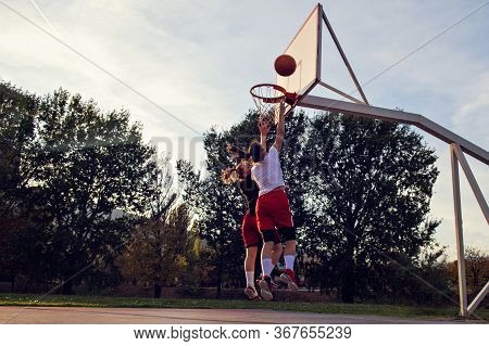 Woman Basketball Player Have Treining And Exercise At Basketball Court At City On Street