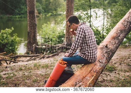 Portrait Young Male Hiker Eating Apple. Tourist At Forest, Stop For Rest And Eat Apple. Fit Man Eati