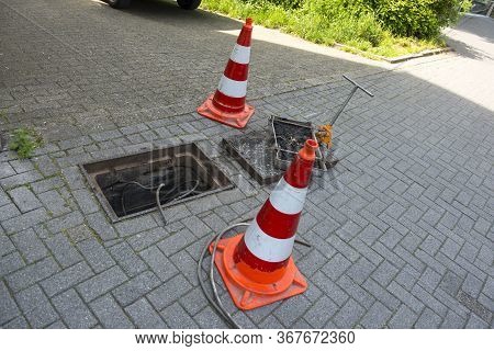 Repair Work On Troubleshooting Or Communal Service Work. Open Iron Hatch With Cable Going Inside