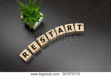 Wooden Blocks With The Text: Restart. New Business Relaunch Startup Concept.