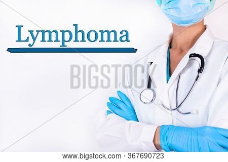 Doctor In Medical Clothes On A Light Background With The Text Lymphoma. Medical Concept.
