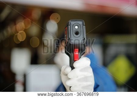 Bucharest, Romania - May 7, 2020: Details With A Shop Security Guard Termoscanning Customers Before 