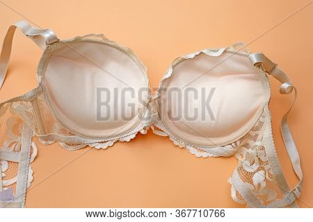 Beige Lace Bra With Push Up On Orange Background. Inner Side. Fashion Lingerie Concept. Beautiful Bo