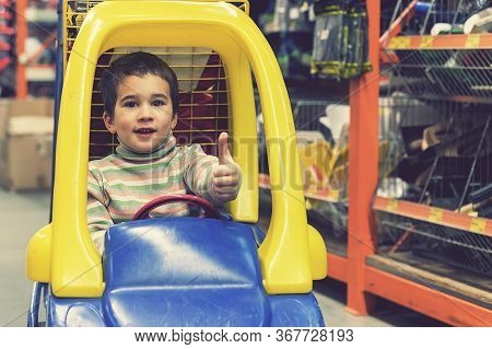 The Boy Is 4 Years Old In A Construction Shopthe Boy Is 4 Years Old In A Construction Shop, Sitting 
