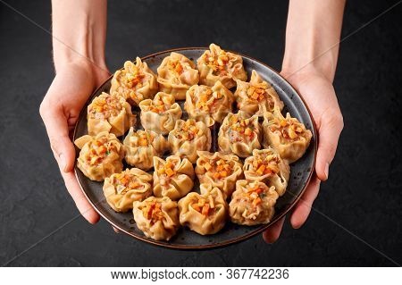 Shumai Or Kanom Jeeb Or Steamed Pork And Shrimp Dumplings On A Black Plate On Dark Slate Backdrop. S