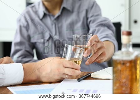 Businessman Put Down Documents And Drink Alcohol. Men Sit At Home During Quarantine And Drink Alcoho