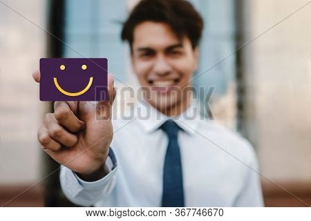 Customer Experiences Concept. Young Businessman Feedback A Happy Face Icon And Positive Review On Ca