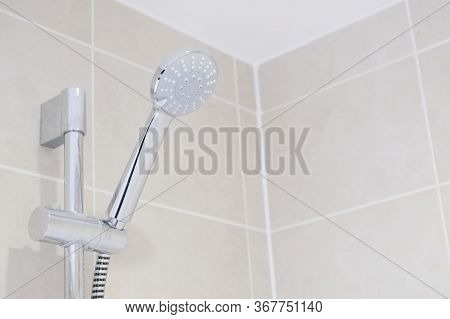 Chrome Modern Shower Head And Neutral Tiles In Bathroom Ensuite