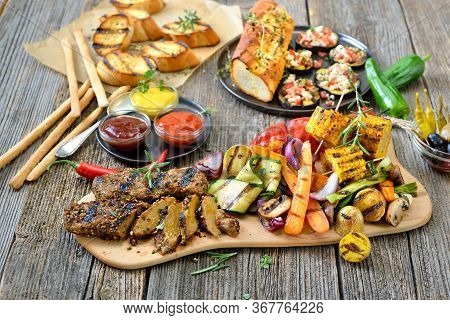 Grilled Vegan Seitan Steaks With Mixed Vegetables, Spicy Sauces And Crusty Baguette