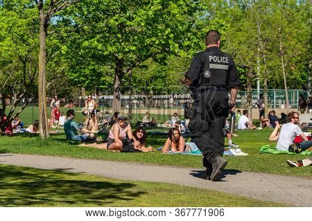 Montreal, Canada - 23 May 2020: Police Patrol Laurier Park To Enforce The Coronavirus Physical-dista