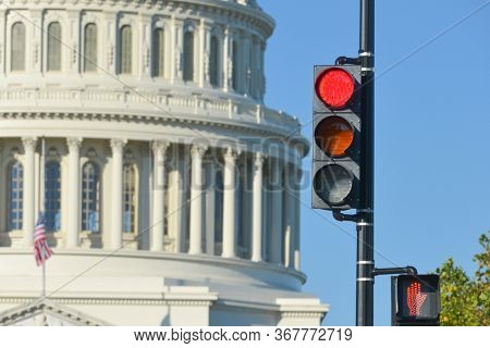 Red traffic light and U.S. Capitol Dome that symbolizes negative political decision -  Washington D.C. United States of America