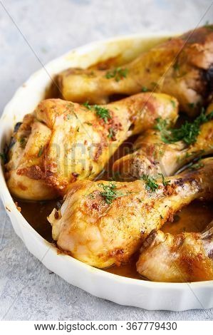 Fried Chiken Drumstick Served In White Bawl Wiht , Salad And Turmeric