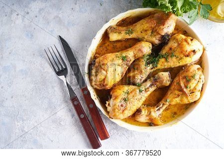 Fried Chiken Drumstick Served In White Bawl Wiht , Salad And Turmeric