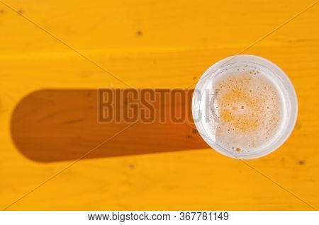 Frozen Homemade Beer In Plastic Glass Sobr Wooden Board At Sunset Casting Shade On The Left