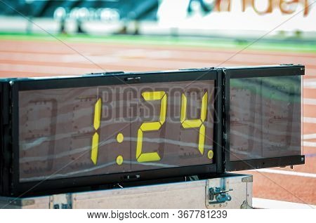 Digital Sport Chronometer In Sport Event Next To Athletic Stadium Tracks