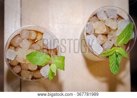 Two Glasses Of Mojito With Ssu Ices Seen Zenital Flat On Wooden Board