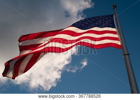 The American Flag Is Waving Against The Sky. Happy 4th Of July Usa Independence Day.