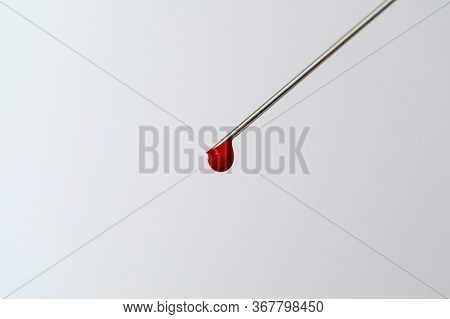 Syringe With A Blood Sample. A Drop Of Blood At The End Of The Needle. Blood Chemistry. Blood Test F