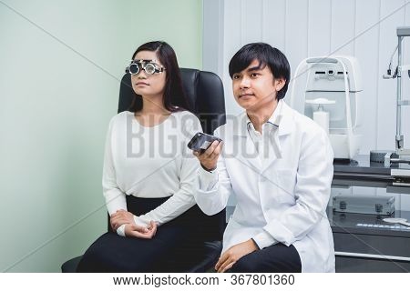 Consultation With An Ophthalmologist. Young Asian Woman And Doctor
