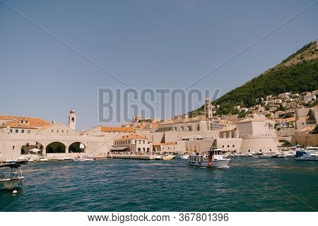 The Old Port Harbor Is Porporela, Near The Walls Of The Old Town Of Dubrovnik, Croatia. A Ship With 