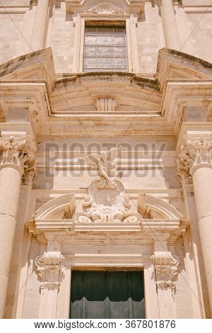 Facade Of The Church Of Saint Ignatius In Dubrovnik, Croatia. Statue Of An Angel Above The Entrance 