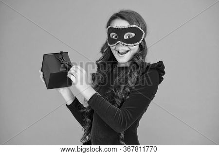 Winter Event And Entertainment. Secret Santa Gift Concept. Kid Wear Eye Mask. Girl In Mask Orange Ba