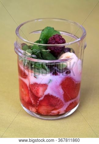 Non-alcohol Fruit Cocktail With Strawberry And Blackberry In Yogurt With Mint In The Transparent Gla