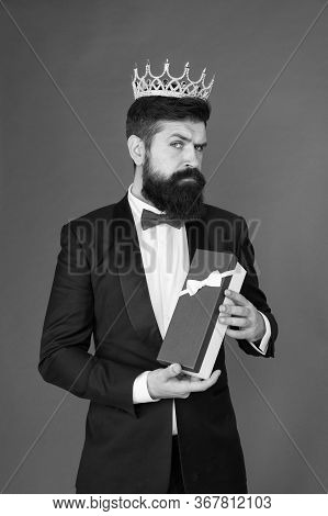 Being Complete Egoist. Egoist Hold Present Box Red Background. Bearded Man Wear Crown. Egoist Or Big