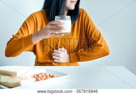 Woman Having A Stomach Pain With A Glass Of Milk At Home,allergy Dairy Intolerant,lactose Intoleranc