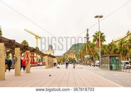 Barcelona, Spain - November 08 2018: Wide Sidewalk In La Rambla With Men Cycling, People Walking And