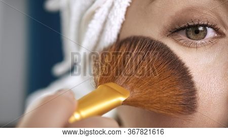 Girl Applying On Face Shine For Skin. Macro Shot Of Attractive Woman With Towel Puts Highlighter Or 