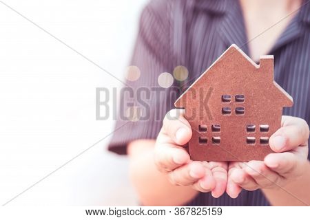 Copyspace Model Of A Little House That Woman Holds It Background.