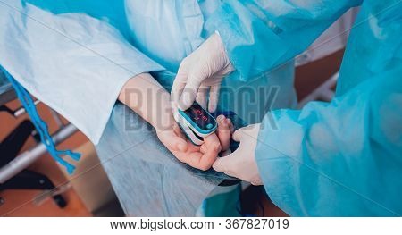 Pulse Oximeter On The Patients Hand. Surgery Equipment.