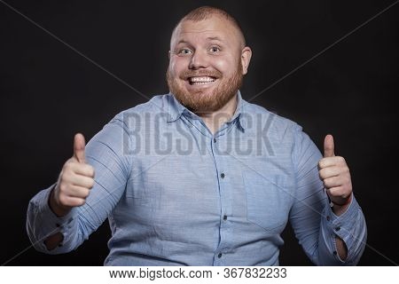 Aughing Fat Redhead Man With A Beard Lives Thumbs Up. Black Background.