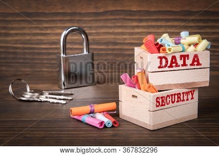Data And Security Concept. Colored Papr Scrolls In Wooden Boxes On Dark Wooden Background