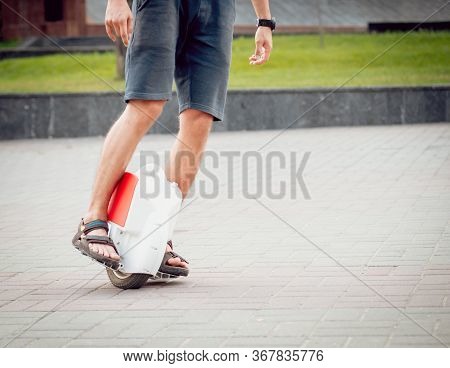 Young Man Driving On Solowheel In The Park.