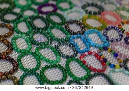 Wide Selection Of Colorful Jade And Other Gemstone Bracelets With Price Tags On Display At The China