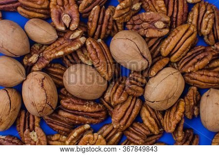 Pekan And Brazil Nuts On Blue Background. Healthy Food