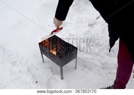 Coals Burning Wood And Bokeh Fire, Flame Ash Blaze Mangal Barbeque. Man's Hands Making Campfire In S