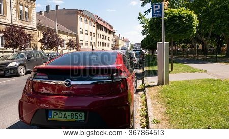 Gyor Hungary 05 21 2020: A Green License Plate Opel Ampera Electric Car Is Parked Next To A Parking 