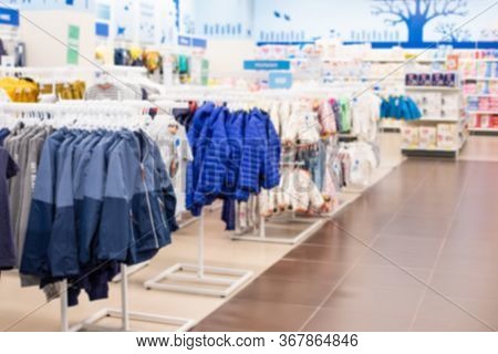 Defocus Background, Children's Clothing Store And Goods For Children. Jackets And Windcheaters On Ha
