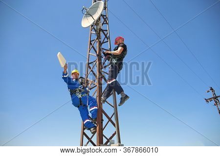 Two Electricians Install 5g Telecommunications System In The Polle