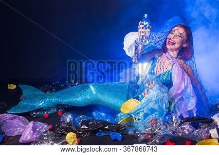Ocean Plastic Pollution Concept. Mermaid Lives To Polluted Habitat.