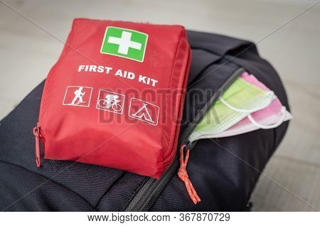 Close Up View With A Backpack With   Two Face Protection Mask  And   First Aid  Kit  Ready For Coupl