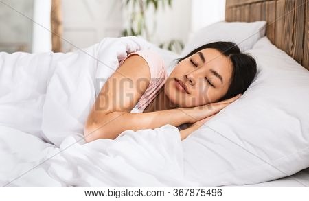 Sweet Dreams. Asian Girl Sleeping Well Lying In Cozy Bed In Bedroom Resting At Home