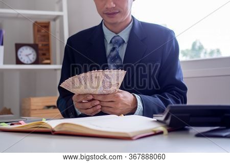 Business People Sit And Count Money Thai Baht On The Desk In The Office, Profitability Of Investment