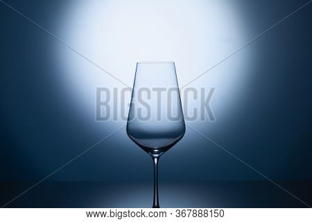 Empty Wine Glass On A Blue Clean Gradient Background. Empty Drinking Transparent Wine Glass